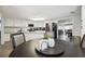 Kitchen and dining area view with granite countertop and a round table at 10208 Grove Dr, Port Richey, FL 34668