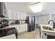 Updated kitchen with white cabinets, granite countertops, and stainless steel appliances at 10208 Grove Dr, Port Richey, FL 34668