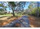 Driveway into property with mature trees at 10208 Grove Dr, Port Richey, FL 34668