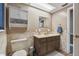 Clean bathroom with brown vanity, tile flooring, and shower/tub combo at 10208 Grove Dr, Port Richey, FL 34668