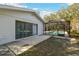 House exterior showcasing a screened pool and backyard at 10208 Grove Dr, Port Richey, FL 34668