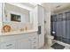 Clean bathroom with white vanity, shower, and ample storage at 10208 Grove Dr, Port Richey, FL 34668