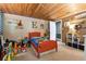 bedroom with red bed, toy storage, and wood ceiling at 10208 Grove Dr, Port Richey, FL 34668