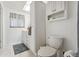 Simple bathroom with white vanity, toilet, and updated flooring at 10208 Grove Dr, Port Richey, FL 34668