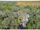 An aerial view of a home and a pool in a wooded setting at 10208 Grove Dr, Port Richey, FL 34668