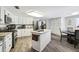 Open kitchen with granite countertops and island at 10208 Grove Dr, Port Richey, FL 34668