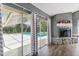 Comfortable living room with a view of the backyard pool and patio at 10208 Grove Dr, Port Richey, FL 34668