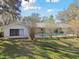 House exterior showcasing a screened pool and backyard at 10208 Grove Dr, Port Richey, FL 34668
