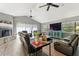 Spacious living area with hardwood floors, a fireplace, and ample natural light at 10208 Grove Dr, Port Richey, FL 34668