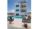 Backyard featuring a private pool, hot tub, dining area, and outdoor grill at 2 4Th Ave, Indian Rocks Beach, FL 33785