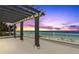 Oceanfront balcony with a stylish pergola feature, offering stunning beach views at 2 4Th Ave, Indian Rocks Beach, FL 33785