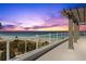 Balcony overlooking the beach with pergola detail, providing shade and style at 2 4Th Ave, Indian Rocks Beach, FL 33785