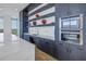 Modern dark wood cabinetry, white counters, and double ovens at 777 3Rd N Ave # 1204, St Petersburg, FL 33701