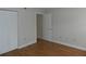 Bedroom with hardwood floors and mirrored closet doors at 201 Cypress Pond Rd # 201, Palm Harbor, FL 34683