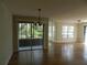 Living room with hardwood floors and sliding glass doors at 201 Cypress Pond Rd # 201, Palm Harbor, FL 34683