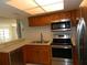 Kitchen with stainless steel appliances and wood cabinets at 201 Cypress Pond Rd # 201, Palm Harbor, FL 34683