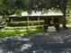 Community clubhouse nestled amongst mature trees and landscaping at 201 Cypress Pond Rd # 201, Palm Harbor, FL 34683