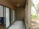 Spacious screened porch with a ceiling fan, and views of the lush landscaping at 201 Cypress Pond Rd # 201, Palm Harbor, FL 34683
