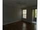 Bright bedroom with wood floors, a ceiling fan, and sliding glass doors to a patio at 201 Cypress Pond Rd # 201, Palm Harbor, FL 34683