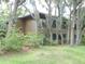 Condo building with mature trees and landscaping at 201 Cypress Pond Rd # 201, Palm Harbor, FL 34683
