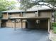 Condo building with carport and landscaping at 201 Cypress Pond Rd # 201, Palm Harbor, FL 34683