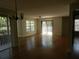 Bright living room with wood-look floors and access to patio at 201 Cypress Pond Rd # 201, Palm Harbor, FL 34683