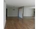 Living room with laminate floors and mirrored wall at 201 Cypress Pond Rd # 201, Palm Harbor, FL 34683