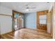 Bedroom with wood-paneled walls, french doors, and ceiling fan at 4822 3Rd S Ave, St Petersburg, FL 33711