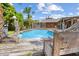 Relaxing pool area with wooden deck and tropical plants at 4822 3Rd S Ave, St Petersburg, FL 33711