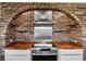 Kitchen features a brick arch, stainless steel appliances, and wood countertops at 4822 3Rd S Ave, St Petersburg, FL 33711