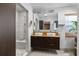 Modern bathroom with double vanity, large mirrors, and a walk-in shower at 4822 3Rd S Ave, St Petersburg, FL 33711