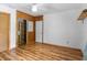 Bedroom with wood-paneled wall, built-in shelving, and hardwood floors at 4822 3Rd S Ave, St Petersburg, FL 33711