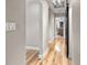 Light and bright hallway with light wood flooring, leading to other rooms at 4822 3Rd S Ave, St Petersburg, FL 33711
