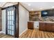 Game room with hardwood floors, barn door, and built-in bar area at 4822 3Rd S Ave, St Petersburg, FL 33711