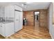 White kitchen with wood accent wall and stainless steel appliances at 4822 3Rd S Ave, St Petersburg, FL 33711