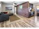Living room features wood floors, exposed brick, and comfortable sectional sofa at 4822 3Rd S Ave, St Petersburg, FL 33711