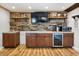 Wet bar with wood feature wall, wine cooler, microwave, and cabinets at 4822 3Rd S Ave, St Petersburg, FL 33711
