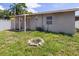 Back of house with covered patio and firepit area at 4822 3Rd S Ave, St Petersburg, FL 33711