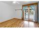 Bedroom with wood-look floors and French doors opening to a view of the pool at 4822 3Rd S Ave, St Petersburg, FL 33711