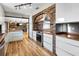 Modern kitchen with wood countertops, stainless steel appliances, and brick accent wall at 4822 3Rd S Ave, St Petersburg, FL 33711