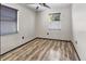 Simple bedroom with laminate wood floors and window blinds at 4822 3Rd S Ave, St Petersburg, FL 33711