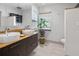 Spa-like bathroom with double sinks, wood vanity, and a separate shower at 4822 3Rd S Ave, St Petersburg, FL 33711