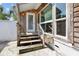 Back patio with wooden steps and exterior door at 4822 3Rd S Ave, St Petersburg, FL 33711