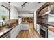 Modern kitchen with wood countertops, stainless steel appliances, and brick accent wall at 4822 3Rd S Ave, St Petersburg, FL 33711