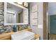 Bathroom boasts wood vanity, contemporary sink, and blue tile at 4822 3Rd S Ave, St Petersburg, FL 33711