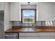 Modern kitchen sink with wood countertop and stainless steel finishes at 4822 3Rd S Ave, St Petersburg, FL 33711