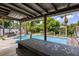 Relaxing pool area with a wooden deck and tropical landscaping at 4822 3Rd S Ave, St Petersburg, FL 33711
