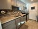 Updated kitchen with gray cabinets and mosaic backsplash at 7200 Sunshine Skyway S Ln # 7E, St Petersburg, FL 33711