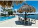 Relaxing pool area with tiki huts at 7200 Sunshine Skyway S Ln # 7E, St Petersburg, FL 33711