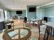Spacious community room with tables, chairs, and a TV at 7200 Sunshine Skyway S Ln # 7E, St Petersburg, FL 33711